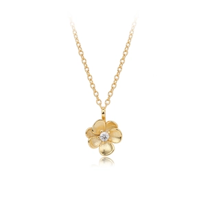 Macro detail of gold flower pendant with frosted petals and center sparkling zircon stone