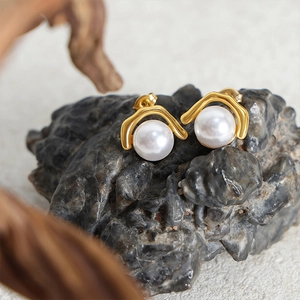 Elegant gold-plated titanium earrings with white round pearls on natural stone base
