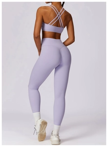 Rear view of purple yoga set featuring crisscross back sports bra and high waist leggings