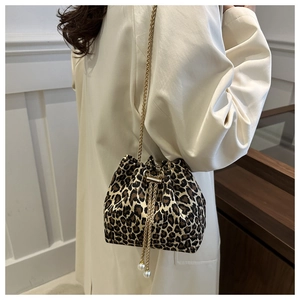 Fashionable leopard print bucket bag with gold chain strap and pearl drawstring details