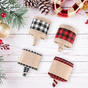 Detail of rustic burlap Christmas ribbons with buffalo plaid patterns on wooden background