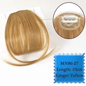 Detail of ginger yellow synthetic air bangs showing 13cm length and secure clip mechanism