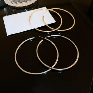 Minimalist thick hoop earrings set in polished gold and silver finish metal