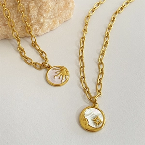 Gold plated titanium steel necklace with sun burst and moon shell pendants