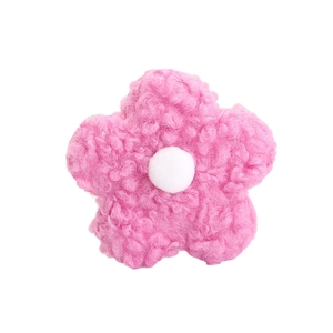 Close-up of 8cm pink and white teddy fleece flower accessory with curly plush texture