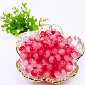 Macro shot of 8mm pink gradient glass beads in a decorative glass bowl for DIY jewelry
