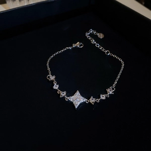 Detailed view of silver star bracelet with sparkling zircon stones on black background