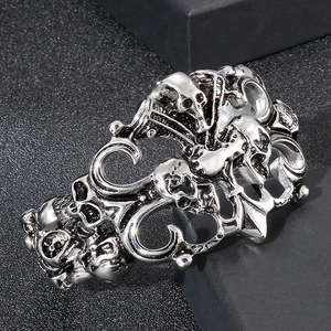 Macro detail of gothic skull engraving on antique silver stainless steel wide cuff bracelet
