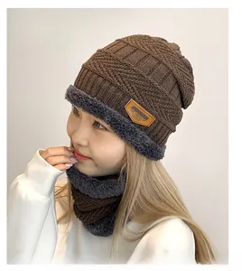 Detail of dark brown knit hat and neck warmer with gray fleece lining for winter warmth