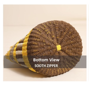 Detailed macro view of the radial hand-woven straw base with colorful striped patterns
