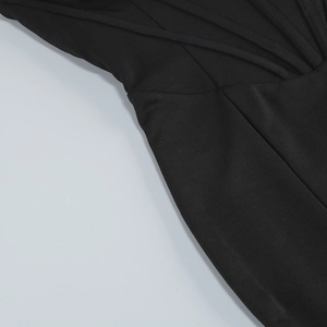 Detail of black mermaid evening dress showing 3D floral accents and stitching on fabric
