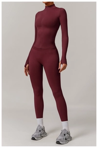 Detail view of burgundy yoga set with zip-up jacket, high waist leggings and thumbhole cuffs