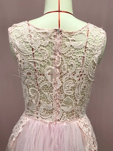 Detail of pink lace and tulle patchwork on sleeveless dress back view on mannequin