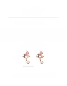 Detail view of pink enamel horse earrings with pearls and zircon stones in gold finish