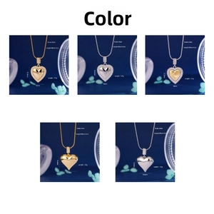 Detail of emerald heart pendant necklace with snake chain and dimensions on blue background