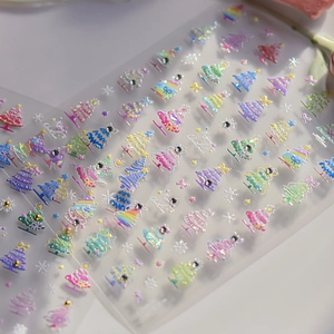 Macro view of 3D embossed Christmas tree nail stickers with colorful rhinestones