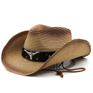 Close-up of western straw hat with leather band and silver bull head ornament details