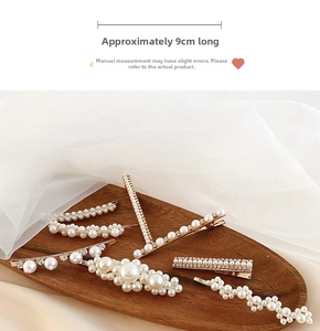 Detail of 9cm pearl hair clip set with rhinestones on a wooden tray with soft lighting