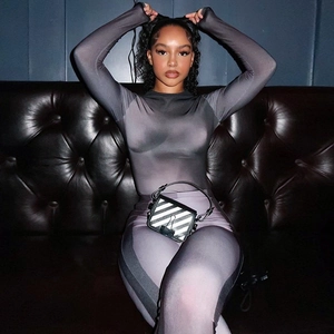 Detailed view of the gradient purple slim fit two-piece knit set on a leather sofa