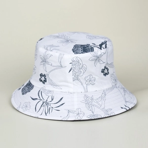 Detailed view of hand-painted blue floral patterns on a white cotton bucket sun hat