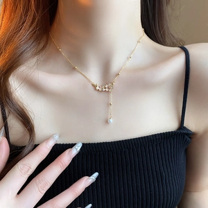 Elegant gold plated necklace with delicate flowers and a hanging white pearl pendant