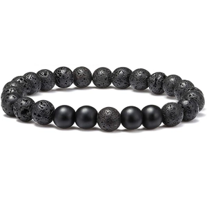 Macro detail of 8mm black lava stone and matte onyx beads with natural texture