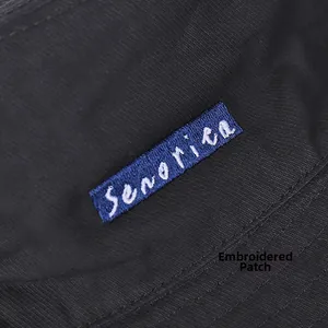 Detail of embroidered Senorita patch on black twill fabric for double-sided sun hat