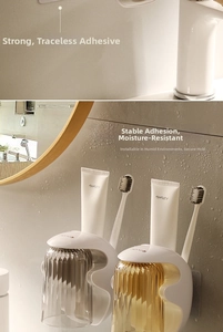 Detail of magnetic wall-mounted toothbrush holder with ribbed textured cups and adhesive base