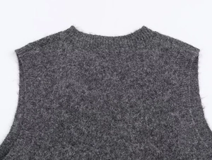 Close-up of the round neckline and wool texture on the gray knitted sequin vest top