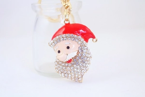 Close-up of Santa Claus keychain with sparkling rhinestones and red enamel finish