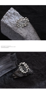 Macro detail of silver S925 ring with irregular bone texture on charcoal background