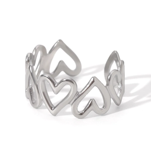 Detail of silver hollow heart-shaped ring with adjustable open band and polished finish