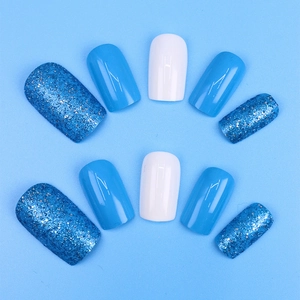 Close-up of blue glitter and solid light blue press-on nails set in short square shape