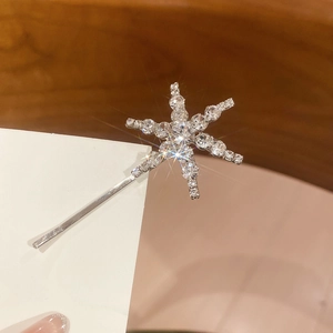 Close-up of snowflake hair clip with shiny rhinestones on silver metal base
