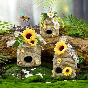 Detailed set of three handmade jute rope beehives decorated with sunflowers and bows