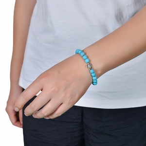 Close-up of 8mm Amazonite turquoise bead bracelet with silver sea turtle charm on wrist