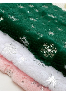 Close-up of plush velvet fabric with silver snowflake patterns for flower wrapping
