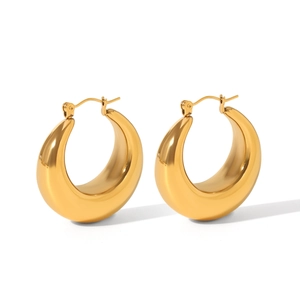 Detailed view of chunky 18K gold plated hollow crescent earrings with polished finish