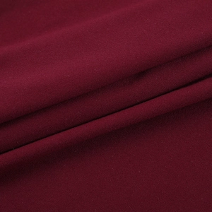 Detailed close-up of wine red knitted fabric texture showing soft high-density fibers