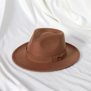 Close-up of caramel wool fedora hat with a matching grosgrain ribbon and bow detail