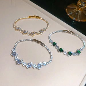 Detailed view of luxury oval zircon bracelets with emerald green and white stones