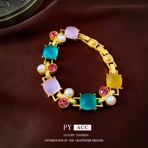 Vintage gold necklace with colorful square gemstones and pearls on brown silk