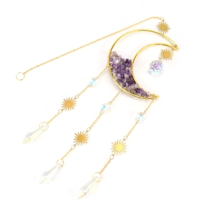 Detail of moon suncatcher with purple crystal gravel and golden sun-shaped metal charms