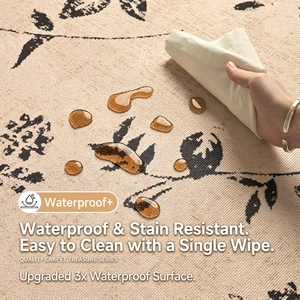 Waterproof beige round rug with black floral pattern showing liquid resistance