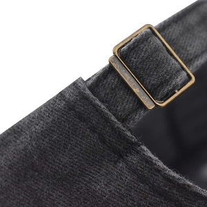 Detail of adjustable bronze metal buckle on vintage washed cotton baseball cap