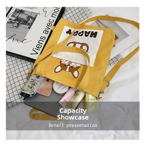 Interior view of yellow canvas tote bag showing large capacity for iPad and umbrella