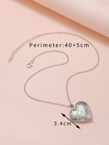 Close-up of engraved silver heart locket necklace with perimeter 40+5cm dimensions