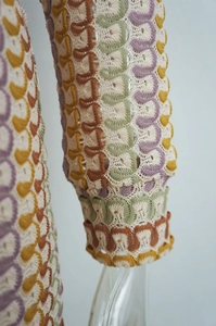 Detail of crochet hollow long sleeve with multi-color wavy stripes and ribbed cuff