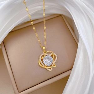 Close-up of double heart titanium steel necklace with sparkling crystal inlay on silk