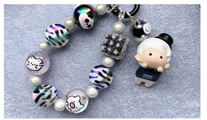 Detailed flat lay of Christmas acrylic candy striped beads and POP MART HACIPUPU figure